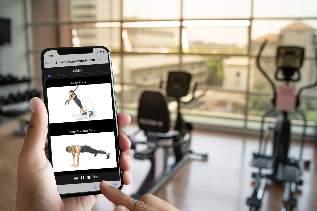 Young man Hand holding smartphone in gym to  fitness phone fitness exercise concept